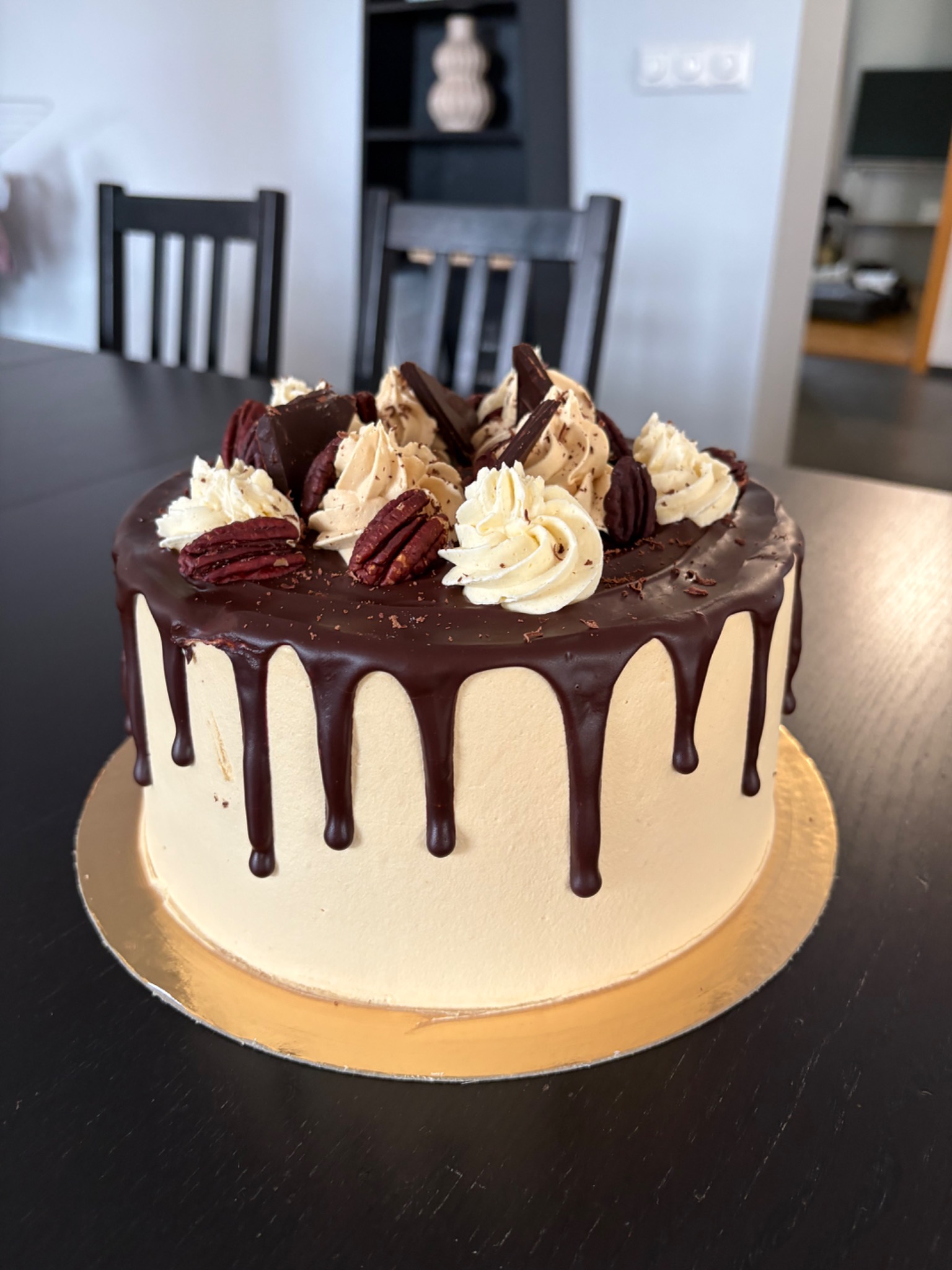 Jimmy’s buttercream cake with chocolate drips, pecans, and piped swirls